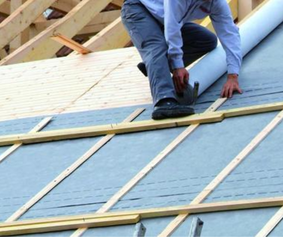 homme qui pose un écran de sous toiture